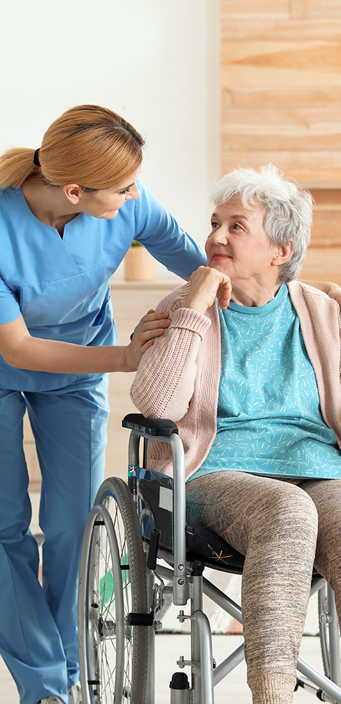 caregiver assisting elderly woman in wheelchair with a warm smile showing compassionate support in health and wellness 10 essential tips for caregivers