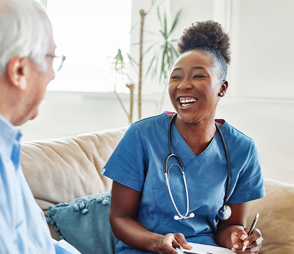 smiling nurse engaging with elderly patient during consultation showing warmth and care in relaxed environment for health support six tips for well being
